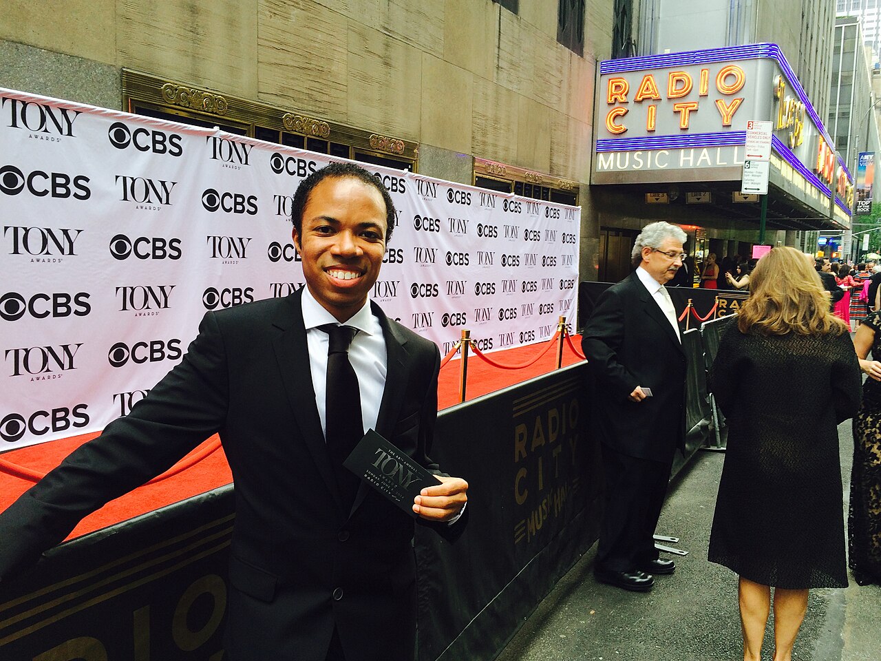 An attendee on the red carpet outside Radio City Music Hall at the 68th Tony Awards, June 8, 2014, before the Tony Awards backdrop