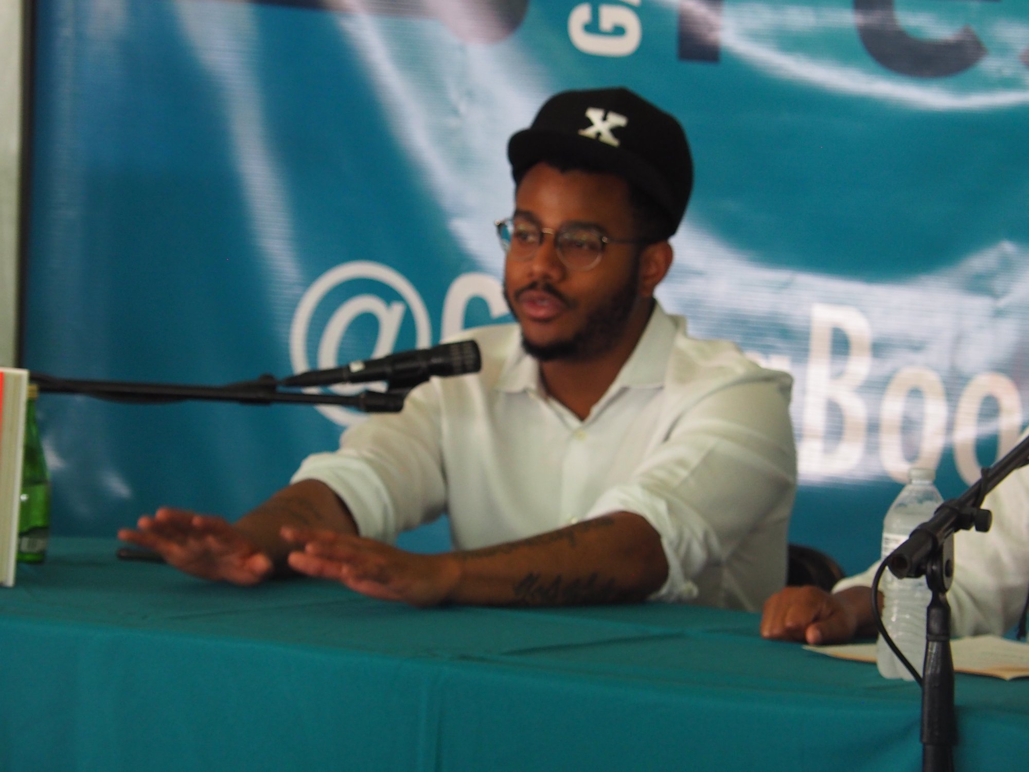 Chef Kwame Onwuachi speaking at a book festival panel.