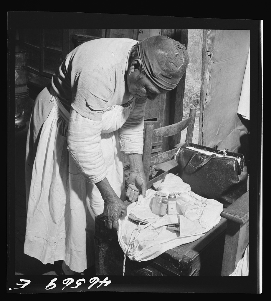 A midwife wrapping her kit to go on a call, Greene County, Georgia, October 1941 (Jack Delano, FSA-OWI)
