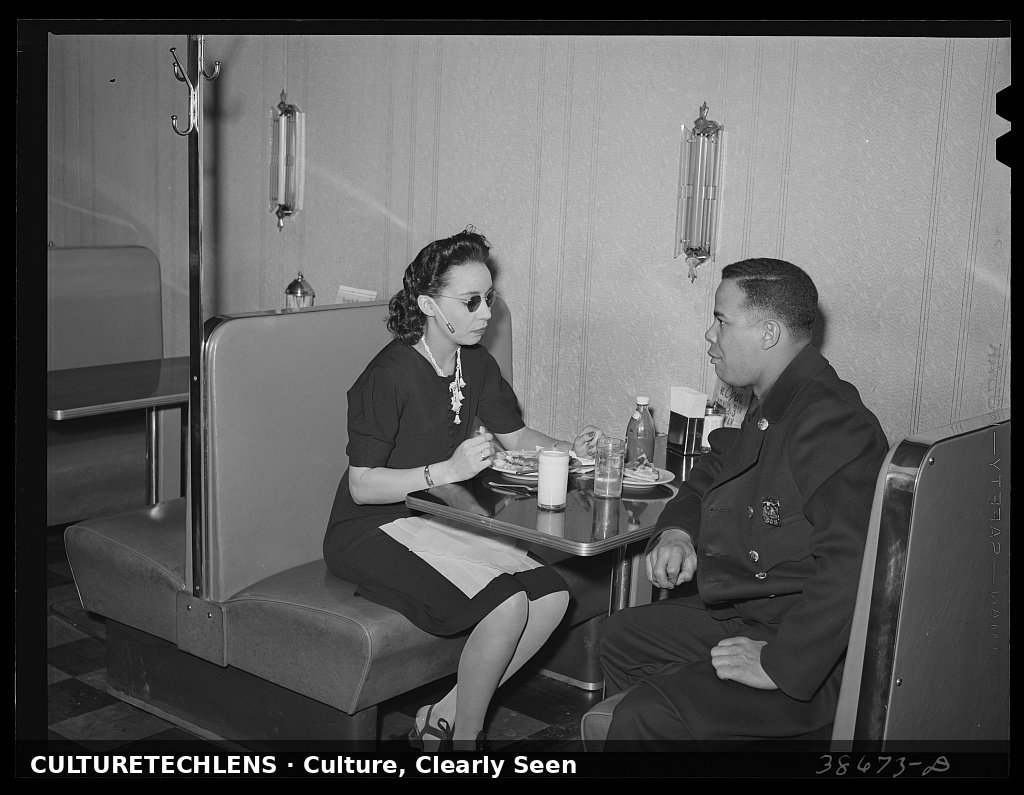 Policeman talking to employee of Ten-cent store whose trade is predominantly Negro. Chicag