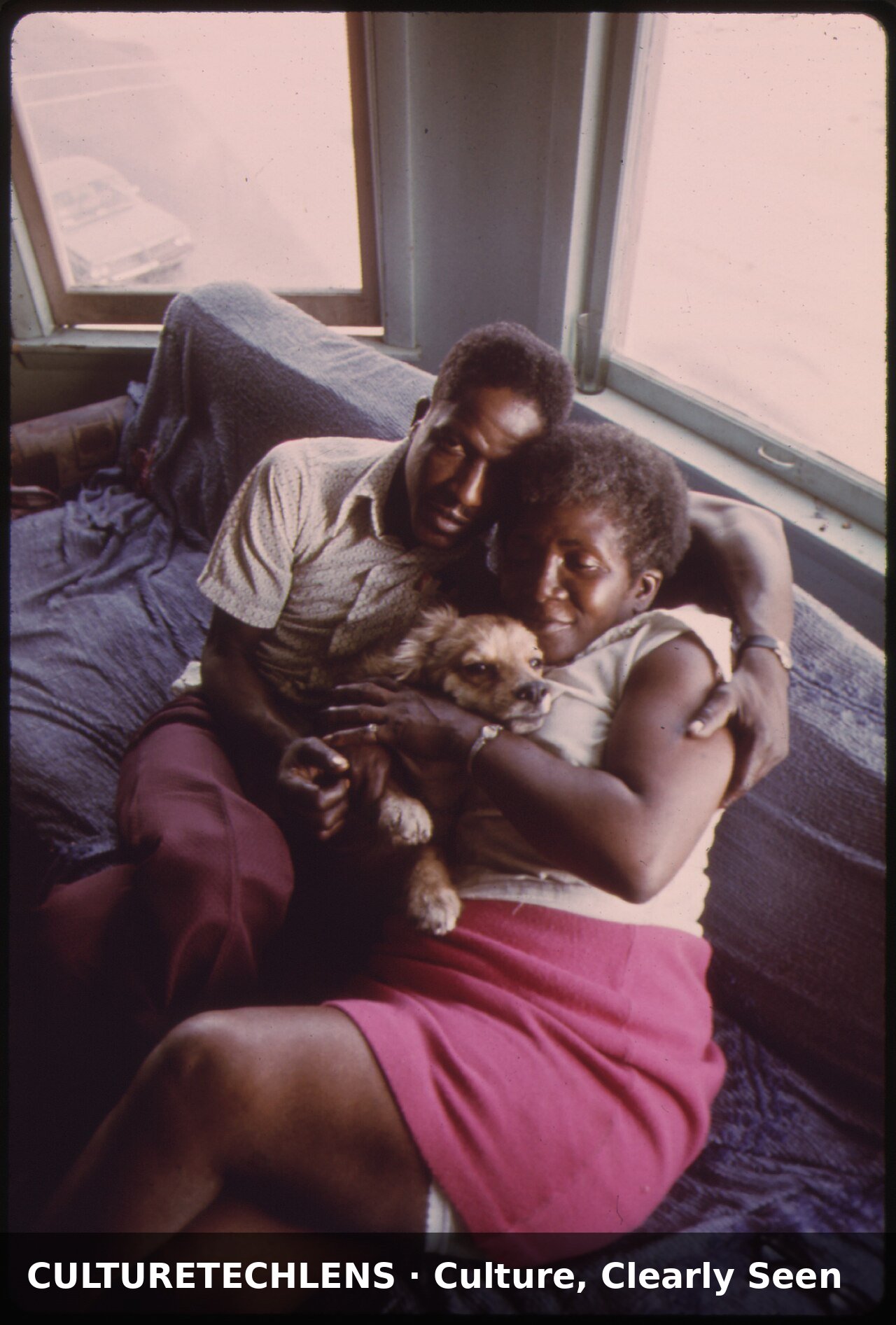 Black couple and their dog in their apartmen, 1973