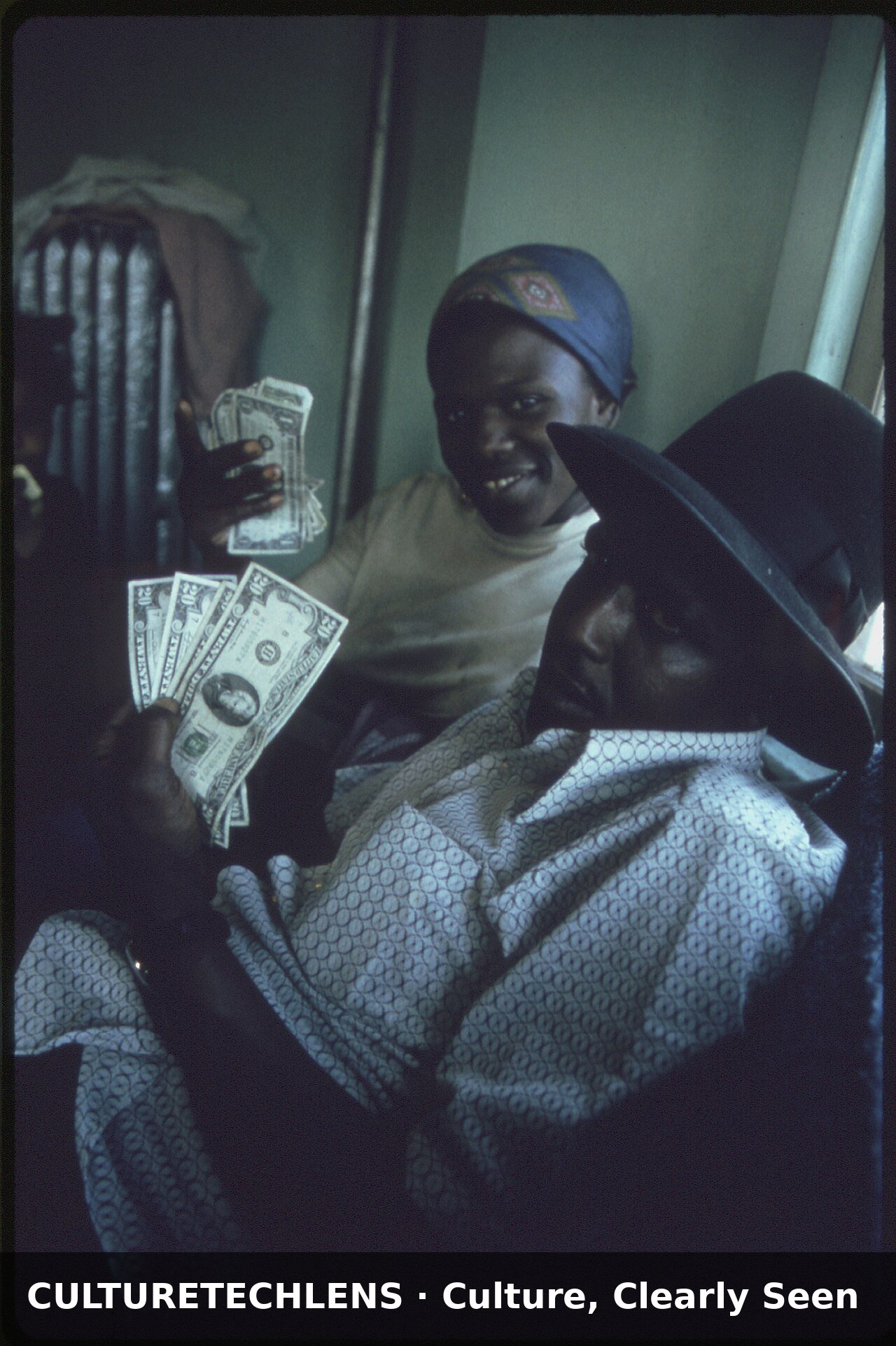 Black family count their cash in their apart, 1973