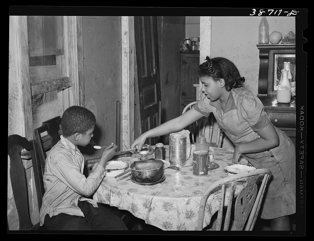 Children at the table in a kitchenette apartment, Chicago, 1941